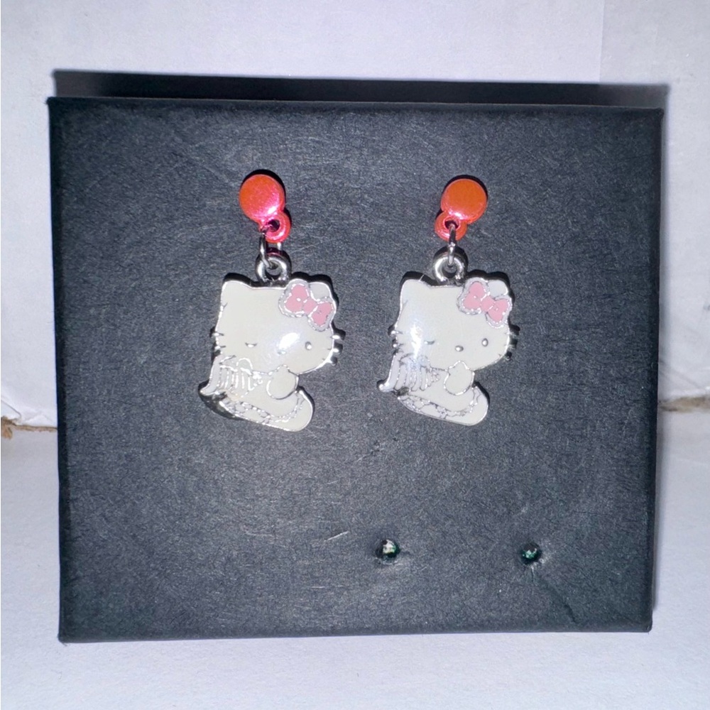 white and pink “angel” hello kitty earrings